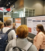Picture of a crowd surrounding a poster at Educause